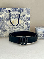 Dark leather belt with round oval Dior logo buckle centered, laid flat