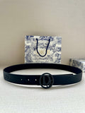 Navy leather belt with oval Dior logo buckle and stitched holes, flat lay