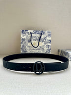 Navy leather belt with oval Dior logo buckle and stitched holes, flat lay