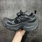 Balenciaga chunky sneakers, dark gray leather-like panels with black mesh and laces