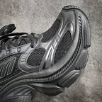 Balenciaga sneakers side view, dark gray leather with ribbed sole and panel logo