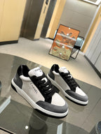 Chanel unisex low-top sneakers, black uppers with white panels and black rubber sole