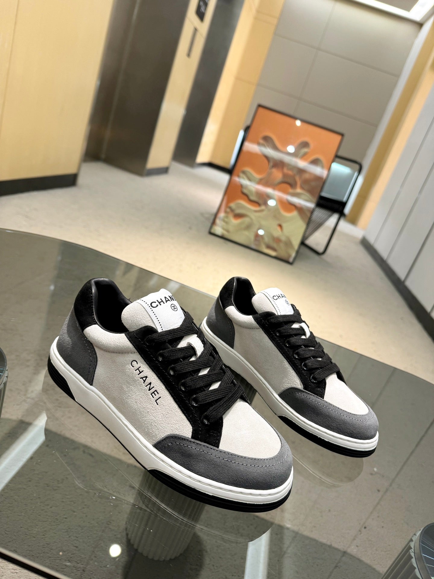Chanel unisex low-top sneakers, black uppers with white panels and black rubber sole