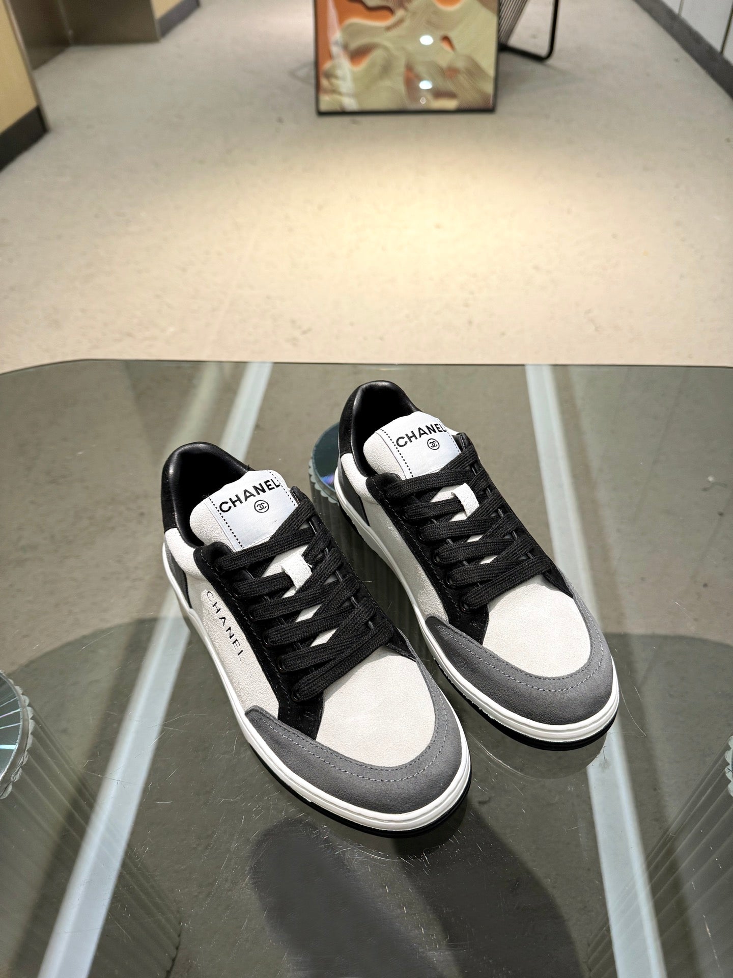 Chanel unisex low-top sneakers, black canvas uppers with white quarter and toe panels