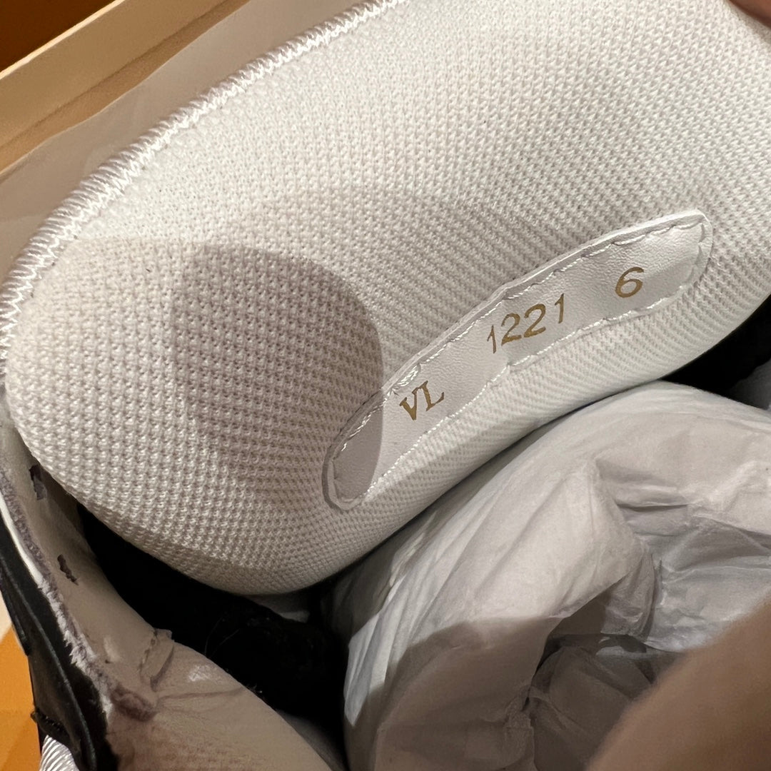 Louis Vuitton sneaker heel close-up, textured light gray sole with embossed numbers