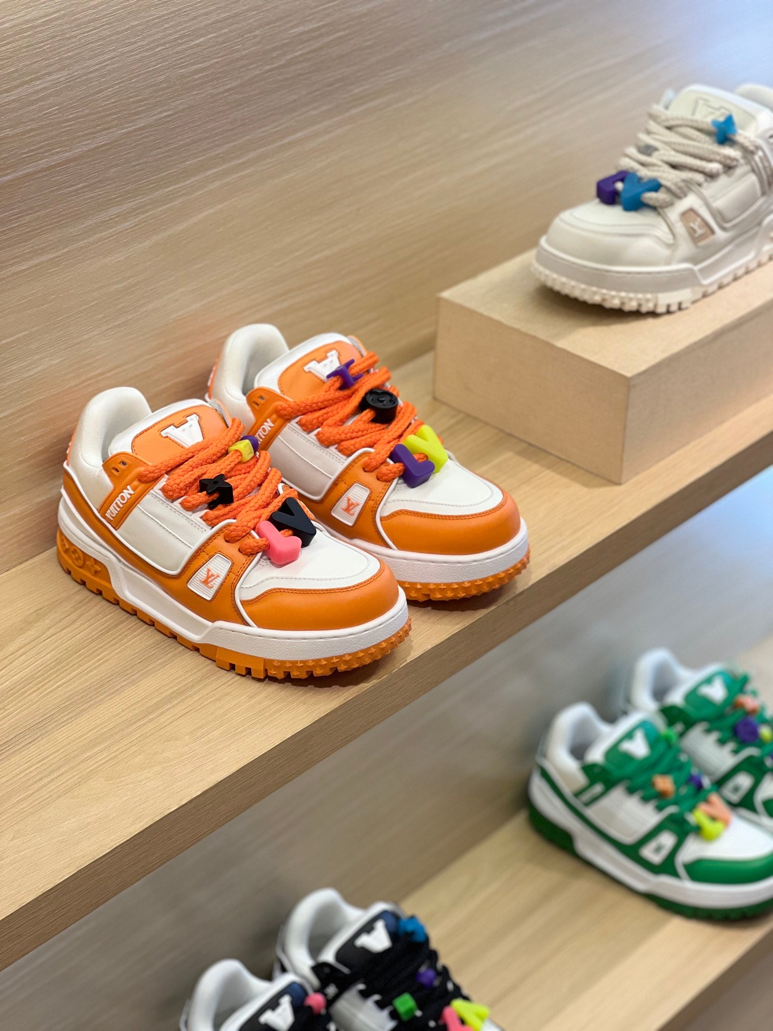 Louis Vuitton trainer sneakers in white and orange with blue and orange lace accents
