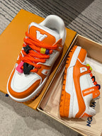 Orange/white Louis Vuitton trainer sneakers with orange laces and charm details