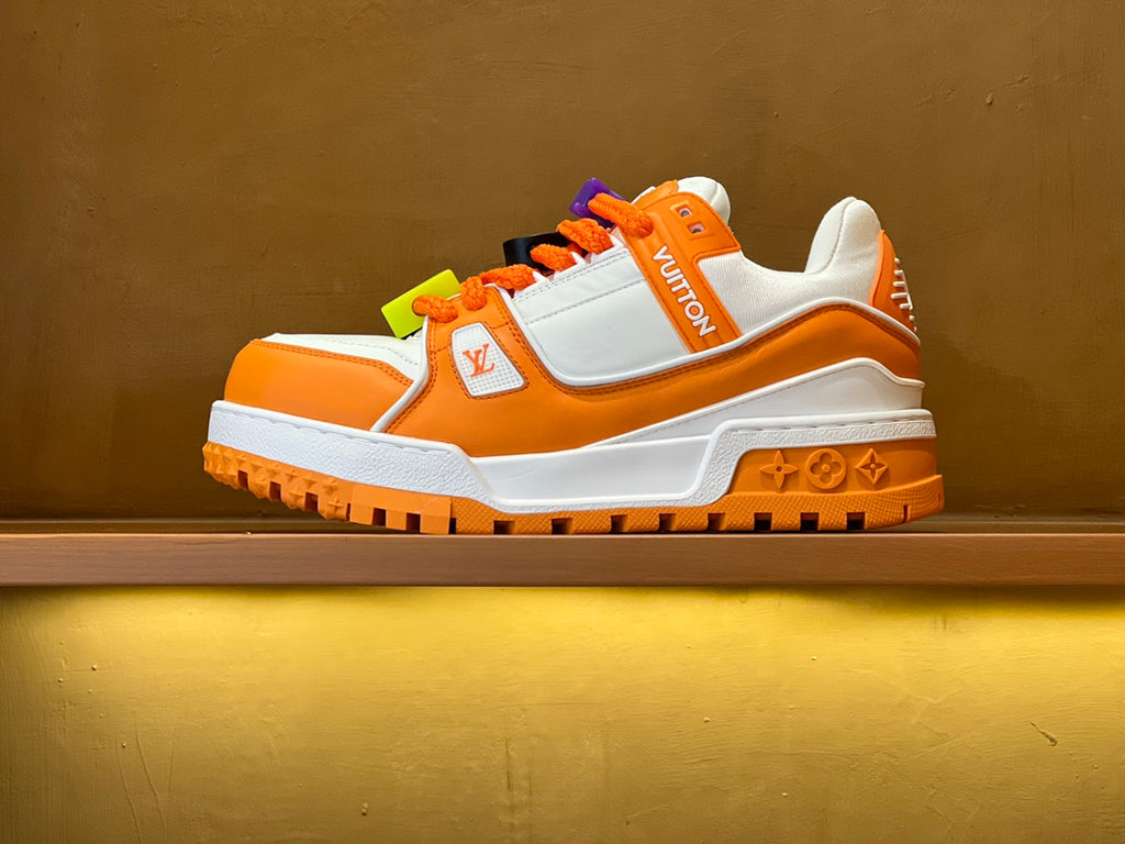 Orange/white Louis Vuitton trainer sneakers with multicolor lace charms and chunky sole