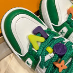 Green low-top sneaker upper with multicolor lace charms and decorative straps