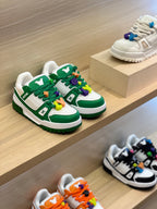 Green-and-white low-top sneakers on display with colorful lace charms