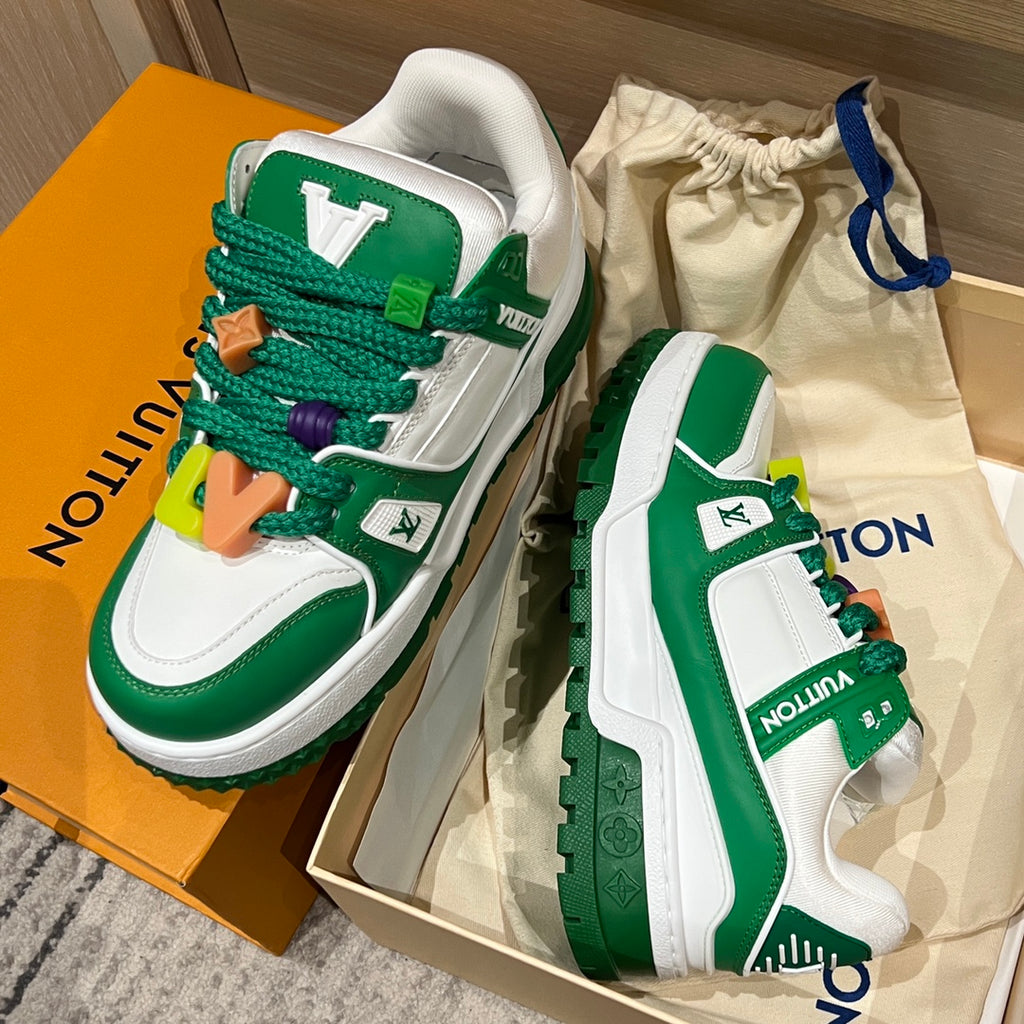 Green-and-white low-top sneakers with colorful lace charms in a gift box