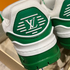 Green-and-white sneaker heel with LV monogram emblem and ribbed stripes