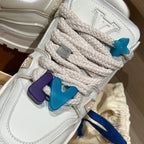 Louis Vuitton trainer shoe close-up, white with woven laces and blue/purple charms