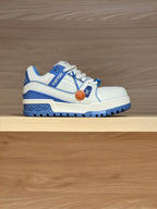 White and blue trainer shoes with blue trim, laces, and LV logo details