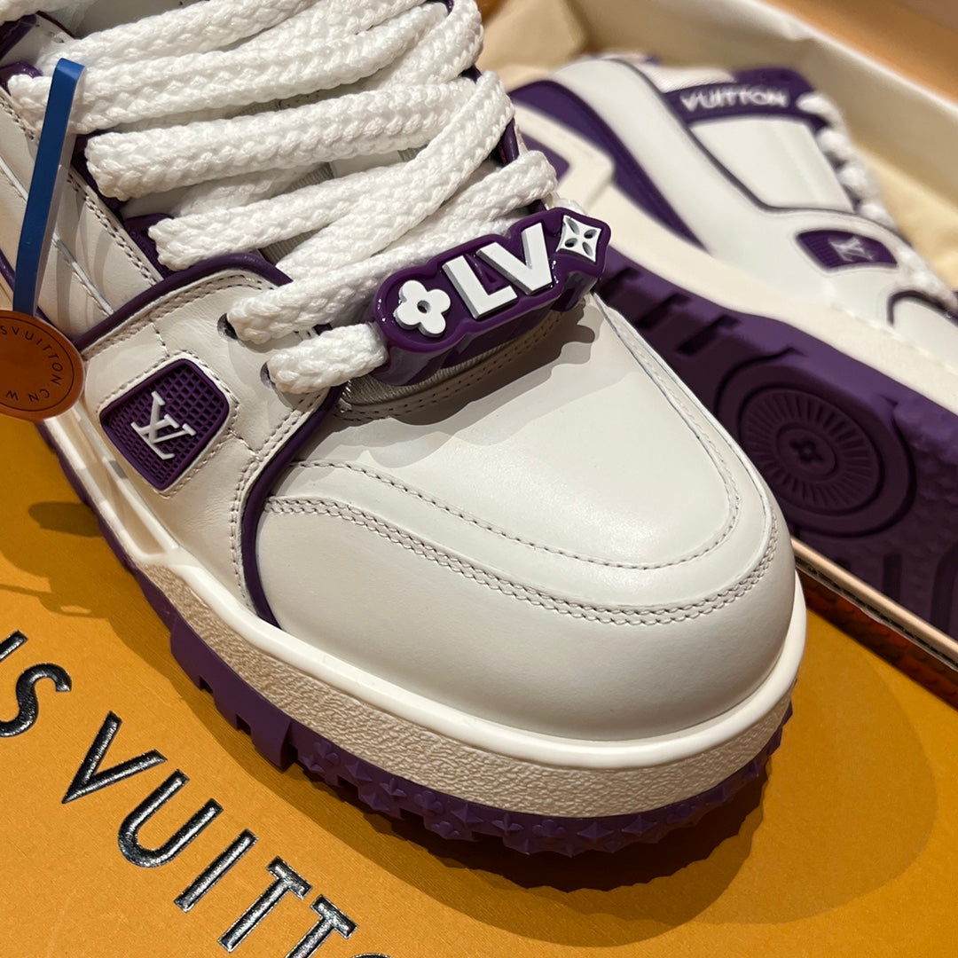 White sneaker close-up with textured sole, white laces, and side logo patch
