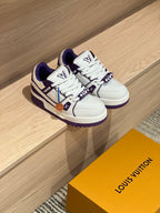 Pair of white and purple low-top sneakers in box, viewed from angled top