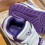 Purple-and-white sneaker outsole close-up with tread pattern and brand lettering