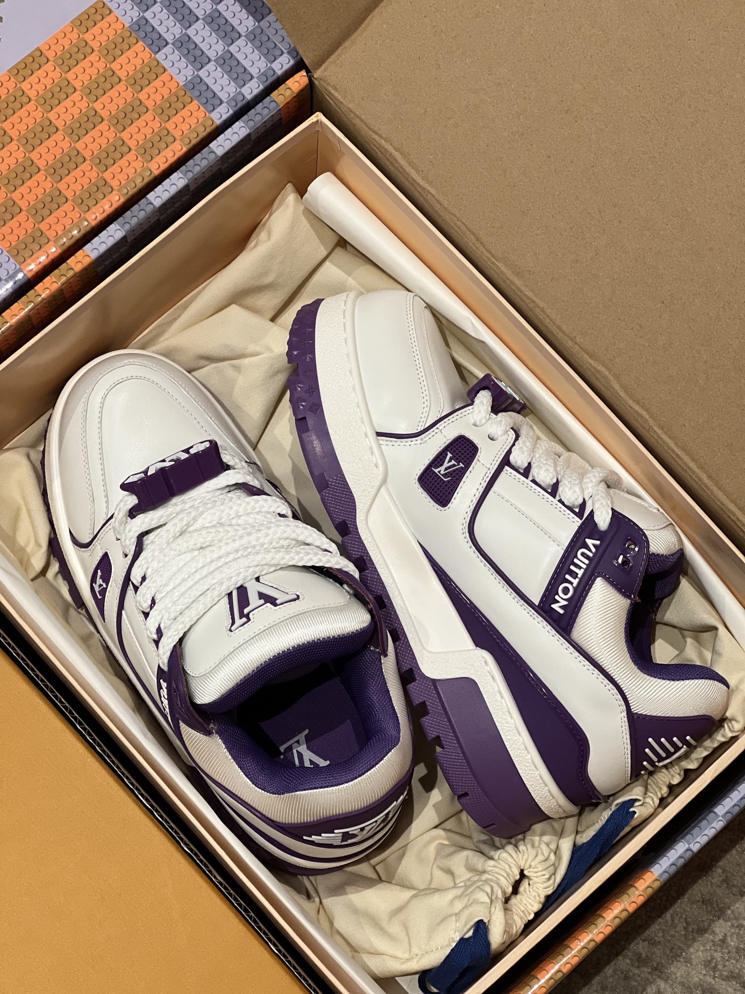White and purple sneakers with thick purple sole and lace-up in open box
