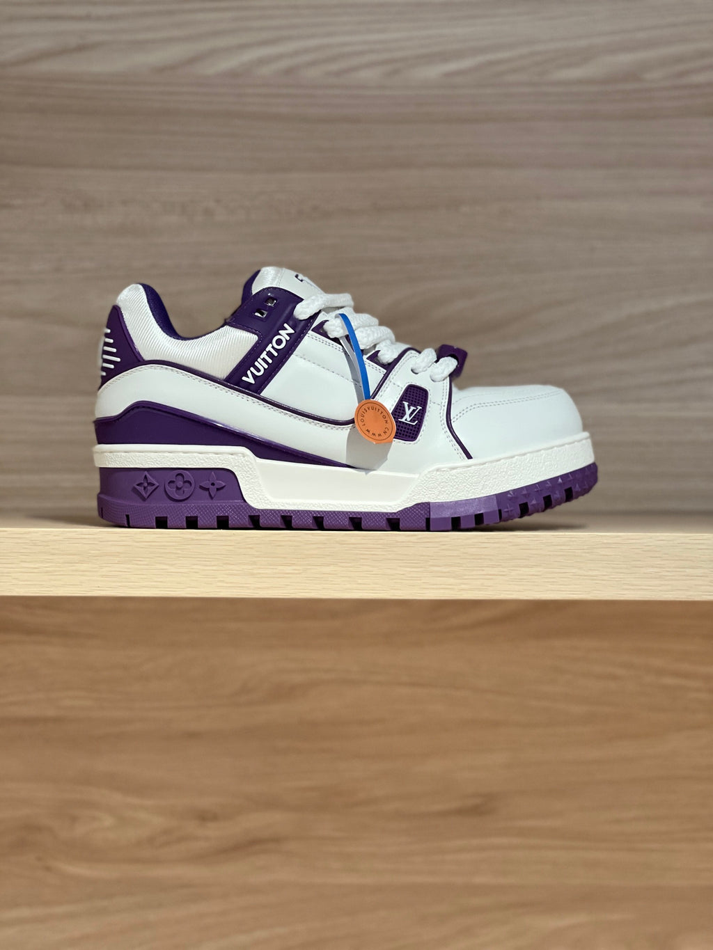 White and purple low-top sneakers with side logo and lace-up closure