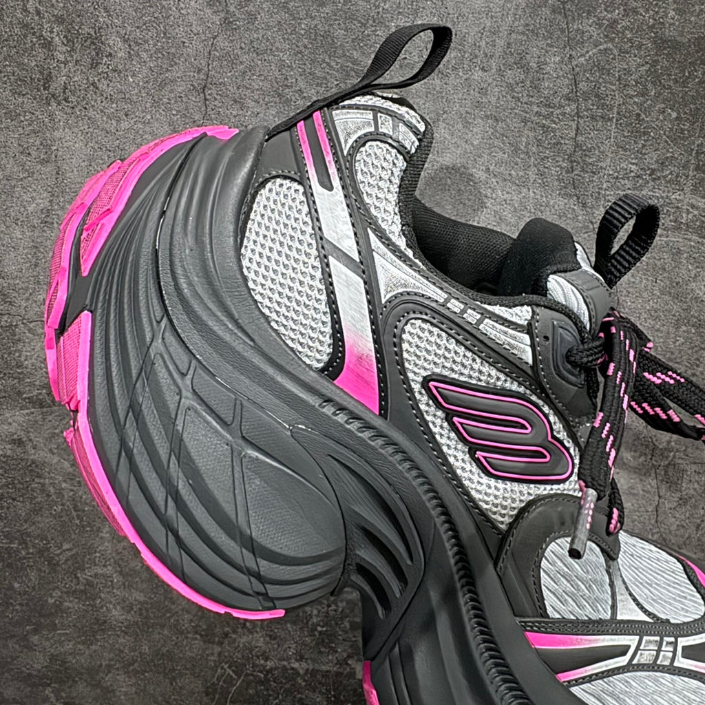 Balenciaga chunky sneaker, lateral side view; black upper with gray panels and pink accents