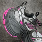 Balenciaga chunky sneaker, lateral side view; black upper with gray panels and pink accents