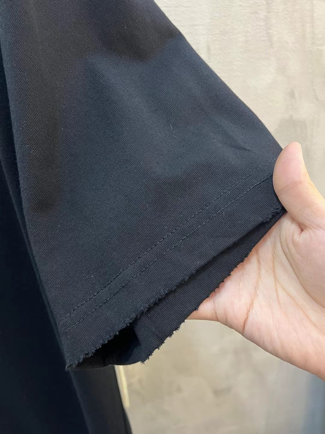 Black T-shirt hem with stitched edge detail