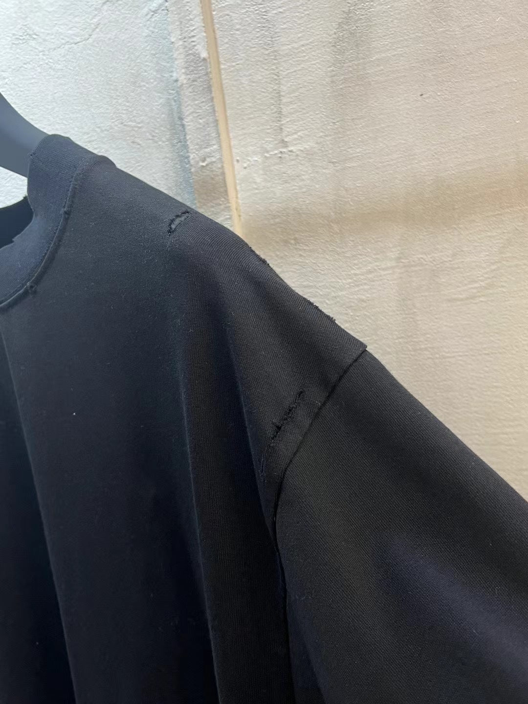 Black T-shirt sleeve and side seam detail