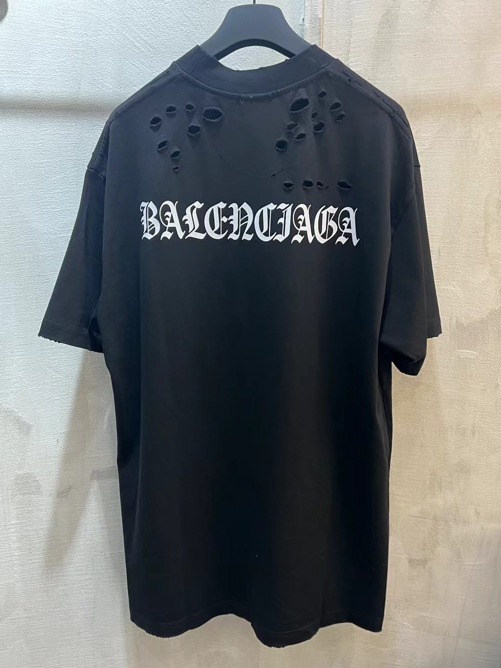 Black crewneck T-shirt with BALENCIAGA cutout logo on chest
