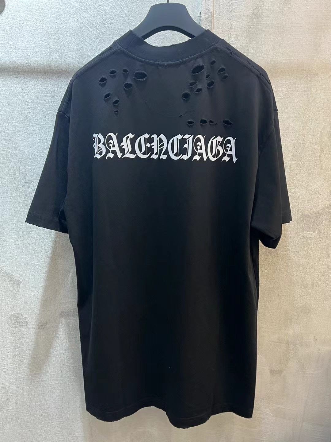 Black crewneck T-shirt with BALENCIAGA cutout logo on chest