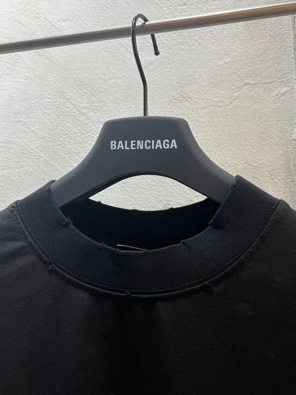 Black crewneck T-shirt neckline with BALENCIAGA logo on inner neck label
