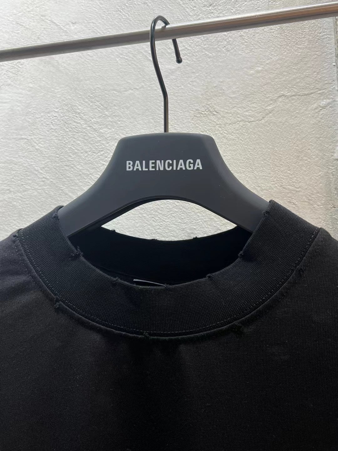 Black crewneck T-shirt neckline with BALENCIAGA logo on inner neck label