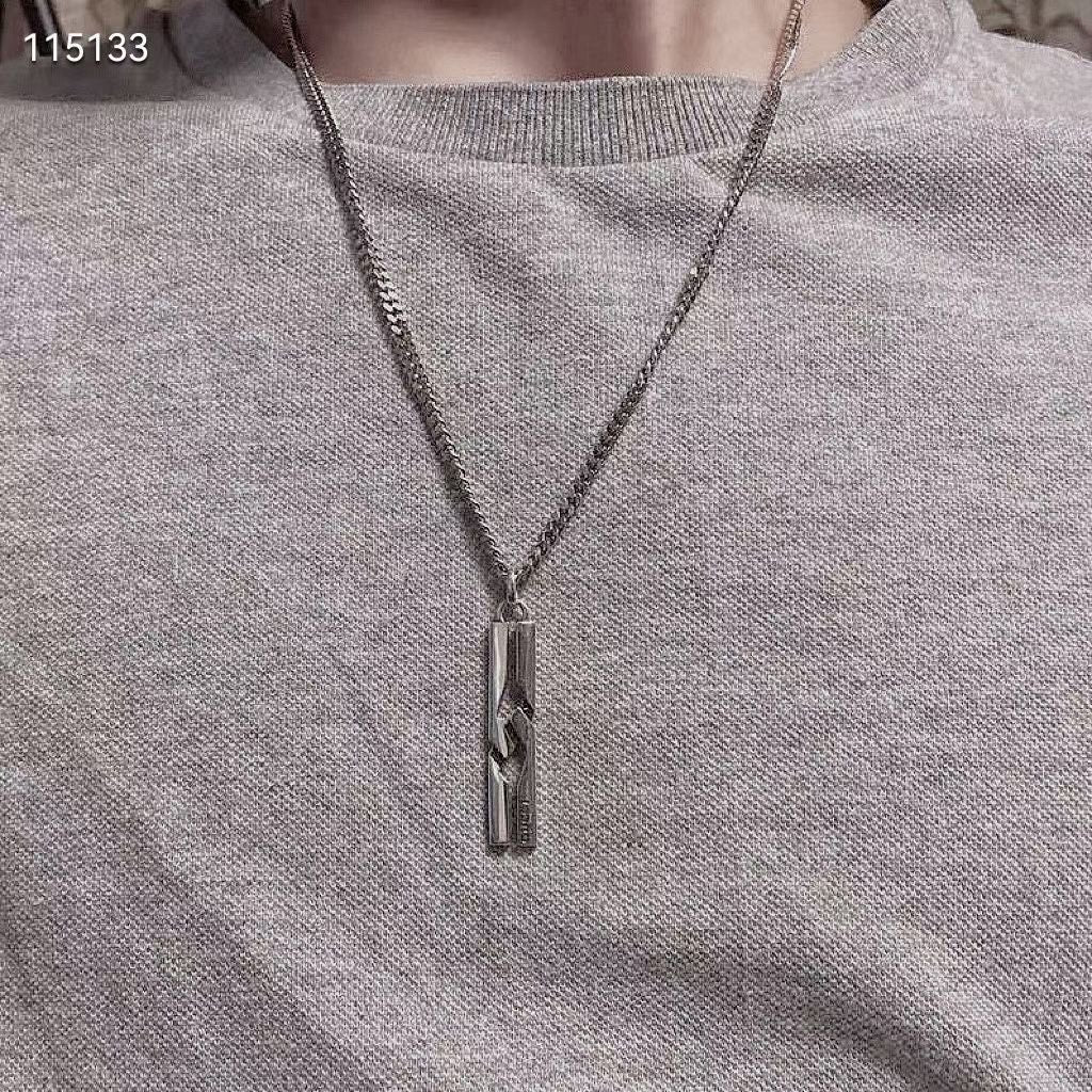 Silver-tone pendant necklace on heather gray knit, rectangular charm at center