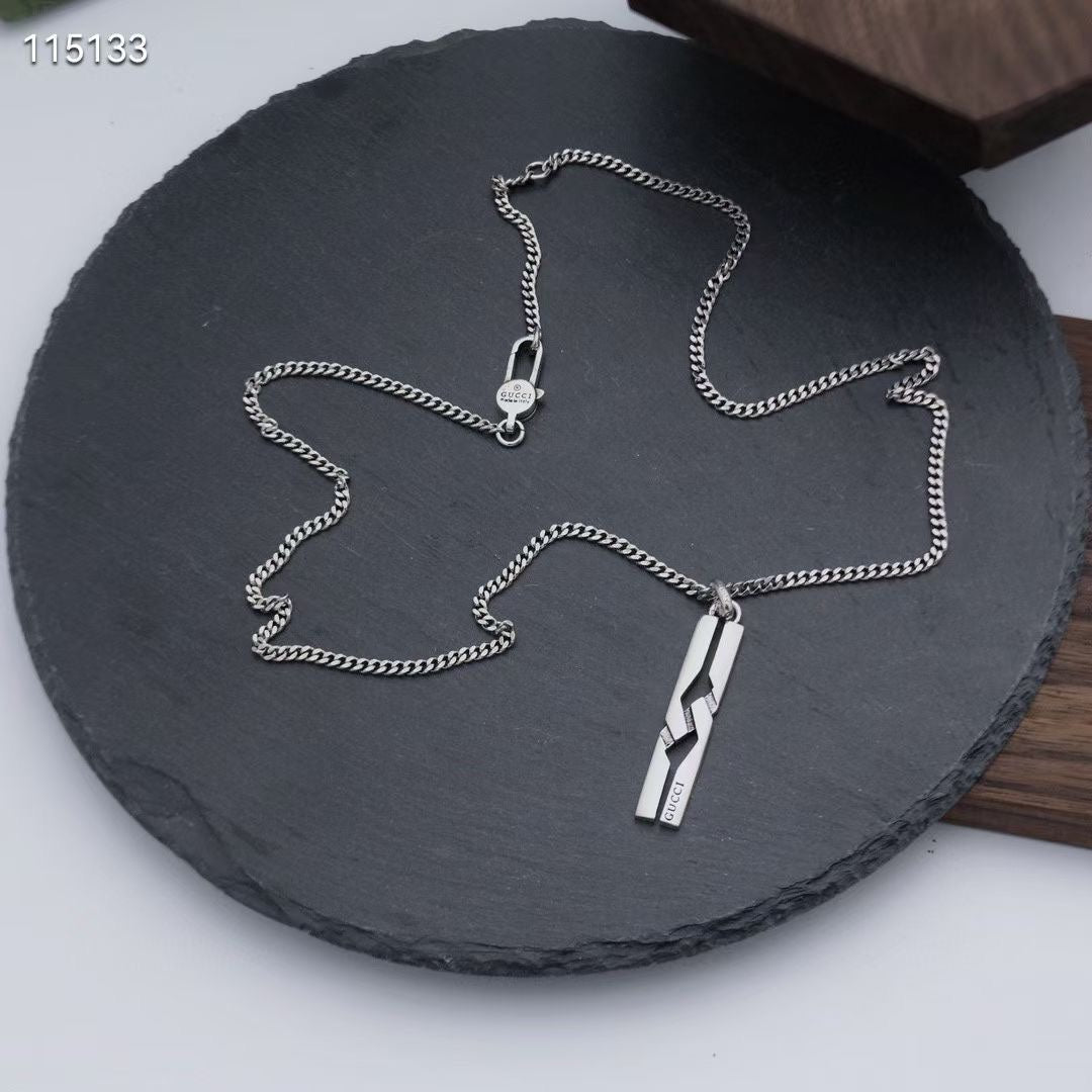 Silver-tone chain necklace with rectangular pendant and small round charm