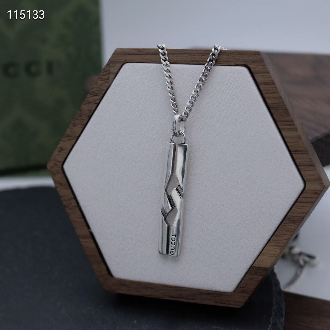 Silver-tone chain necklace with long rectangular pendant on hex display