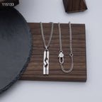 Set of silver-tone necklaces on tray: rectangular pendant, round tag, chain