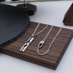 Silver-tone pendant and charm necklaces on wooden tray