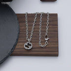 Gucci silver-tone pendant necklace and matching chains on a tray