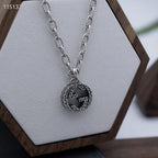 Gucci round logo pendant necklace with linked silver-tone chain, close-up