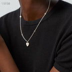 Gucci silver heart pendant necklace worn with a black top, pendant centered