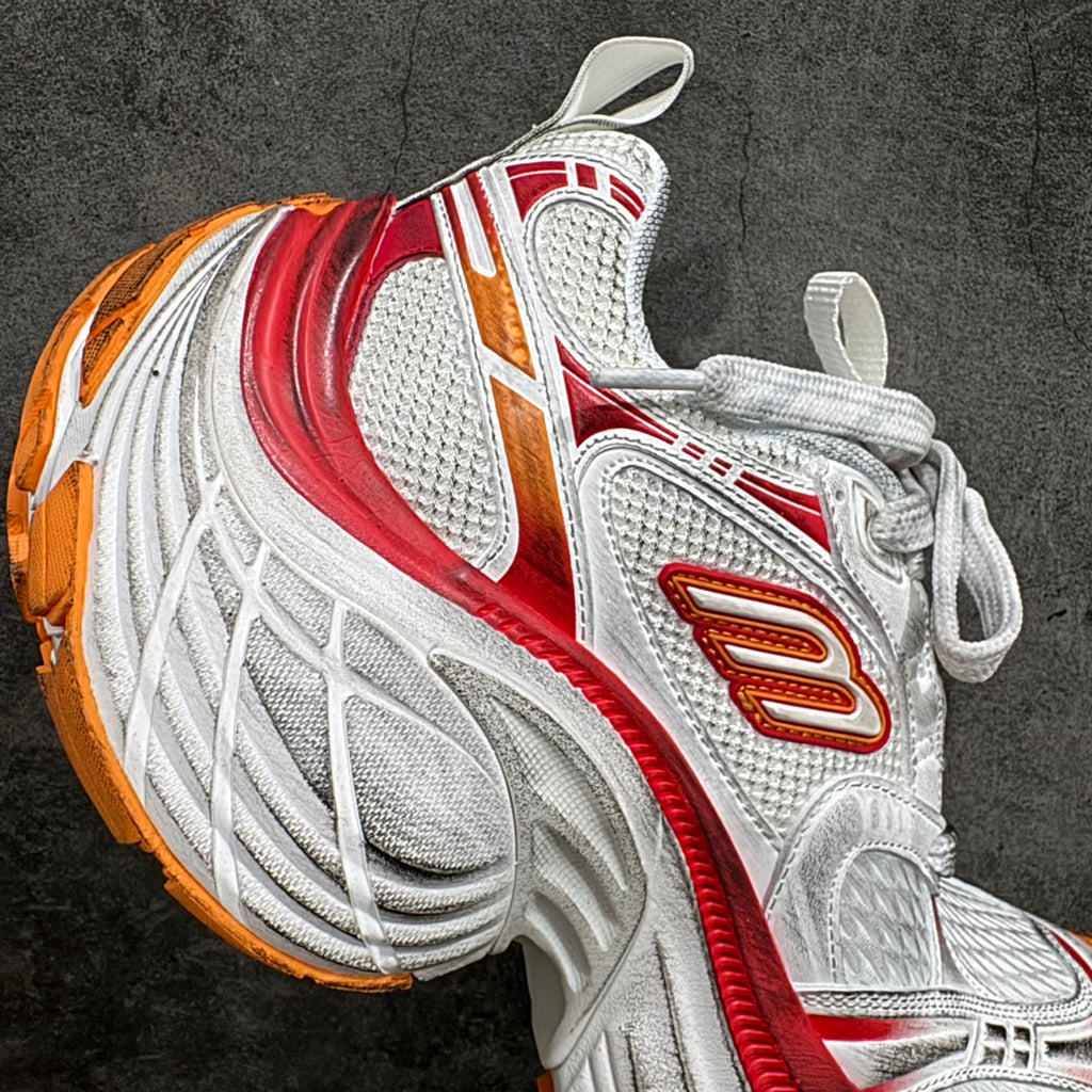 Balenciaga unisex sneakers, side profile in white with red stripe and orange logo detail