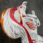 Balenciaga unisex sneakers, side profile in white with red stripe and orange logo detail