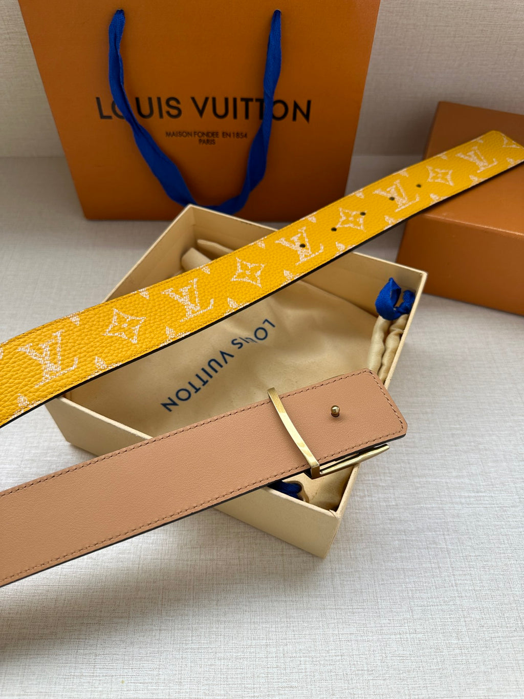 Yellow monogram leather belt with silver LV buckle and tan back strap