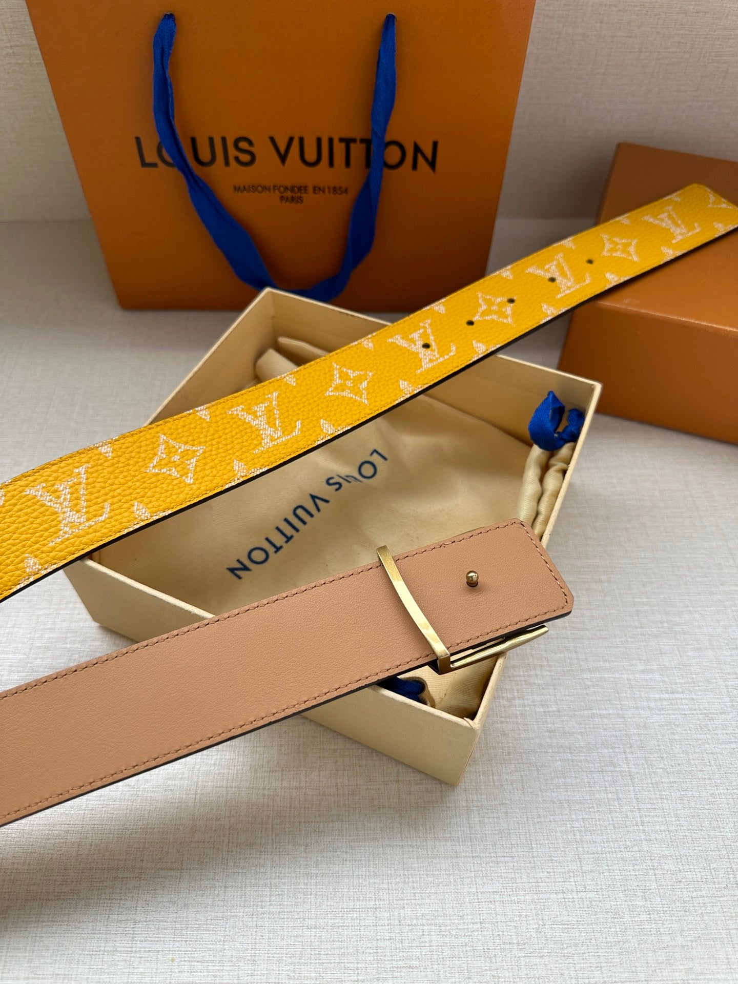 Yellow monogram leather belt with silver LV buckle and tan back strap