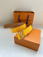 Yellow monogram leather belt with silver buckle and adjustable strap holes