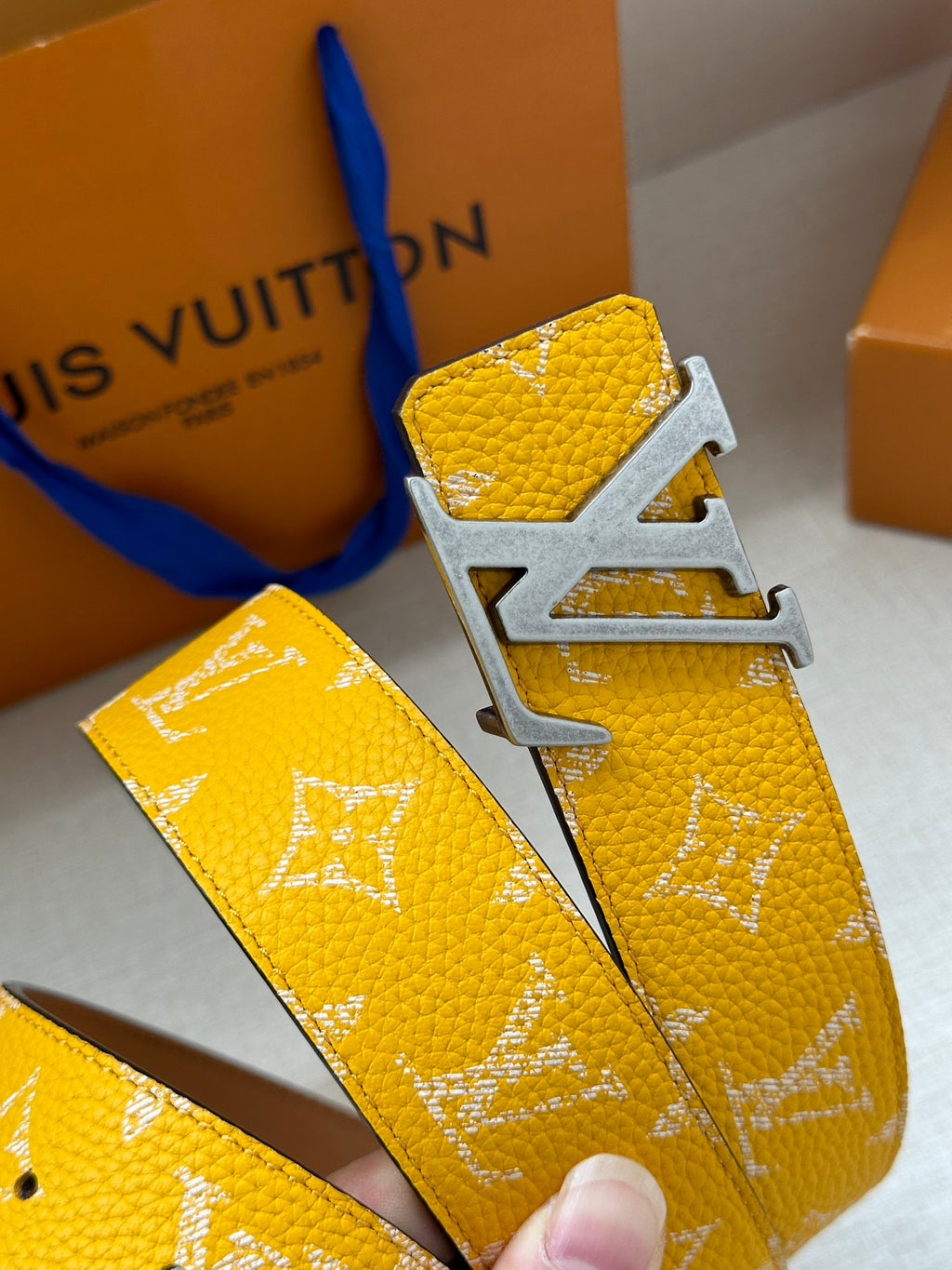 Yellow monogram leather belt with silver LV buckle detail and strap edge