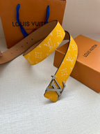 Yellow monogram leather belt with silver buckle, end shows punched holes