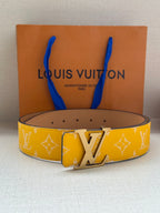 Yellow monogram leather belt with silver LV buckle and tan underside