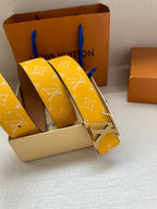 Yellow monogram leather belt with silver LV buckle, stacked strap angles