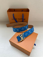 Blue monogram belt with gold-tone buckle on box