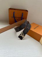 Louis Vuitton monogram belt with dark patterned strap and gold-tone buckle